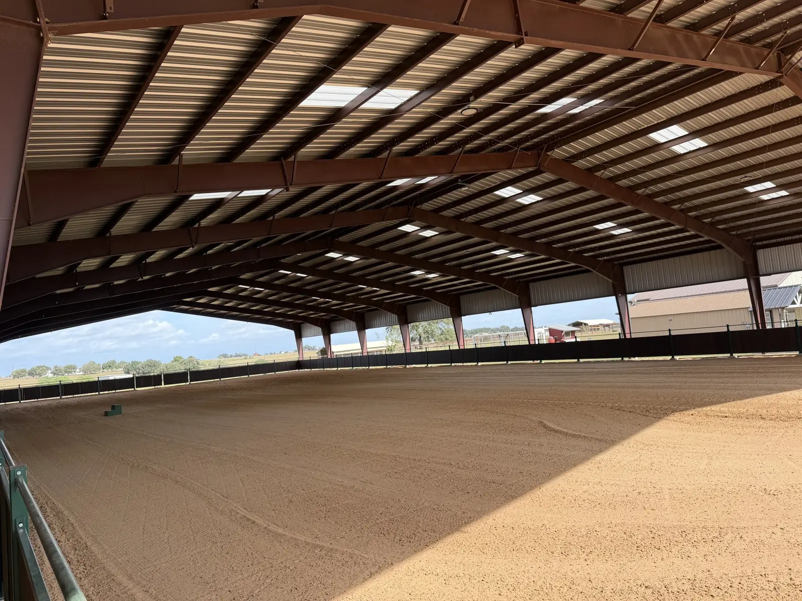 Inside the covered and lighted 200 by 100 foot arena with groomed sand footing
