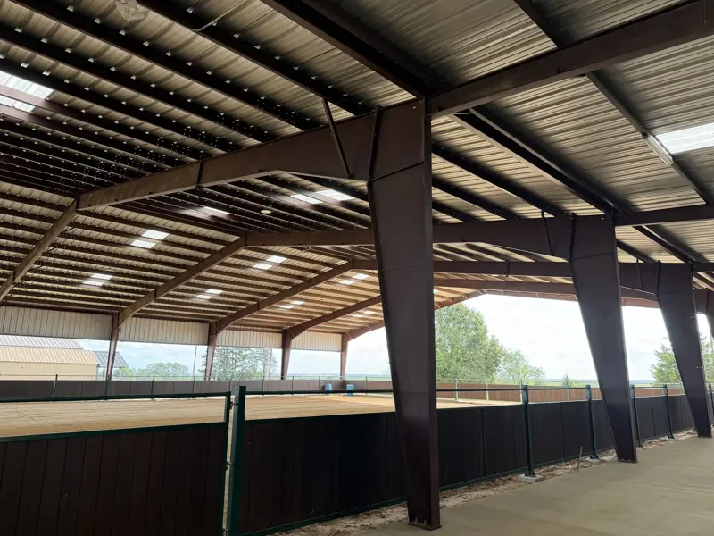 Arena rail and steel posts along the covered arena