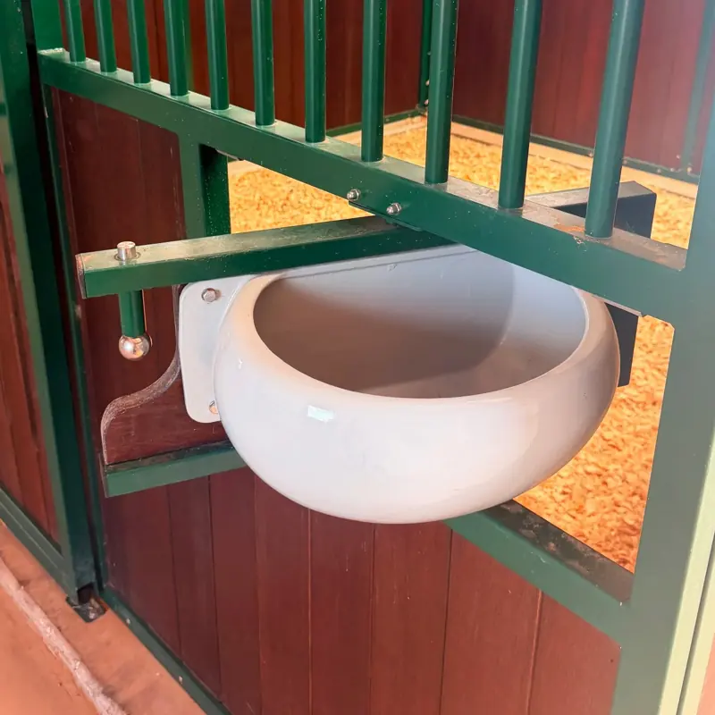 Corner feed bowl and stall front detail in a 12 by 12 foot stall